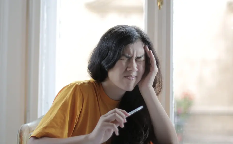 Woman experiencing discomfort due to ringing in her head and ears