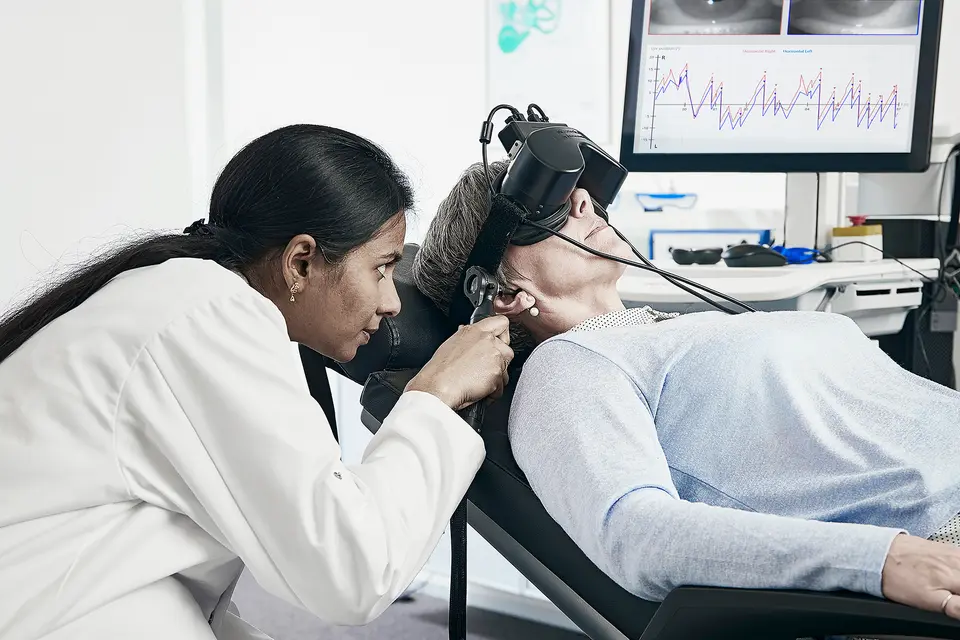 Audiologist and patient doing hearing test