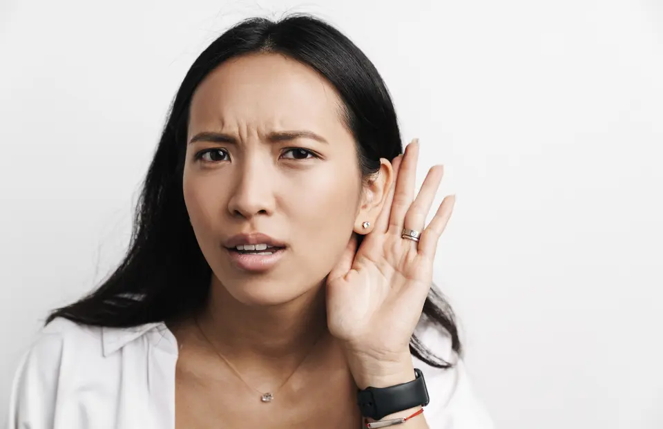 Woman with hearing loss cupping her ear